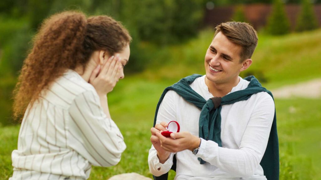 Portrait of Smiling Young Man Opening Ring Box Cant Stop Thinking About Her