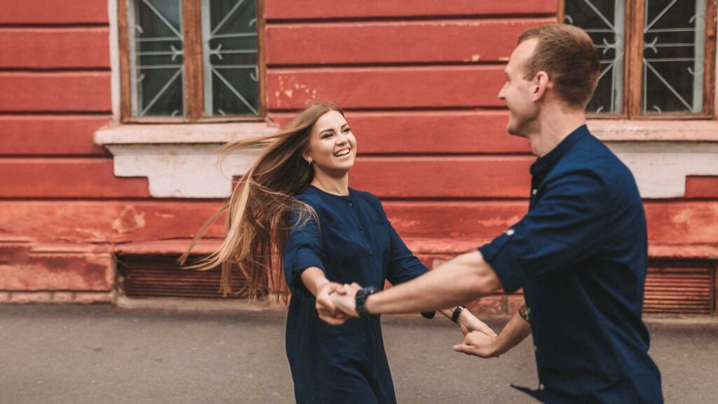 A happy married couple in love runs down the street and rejoice