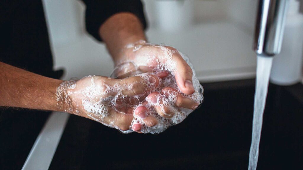 Close up of Masculine Man's Hands in Soap Foam