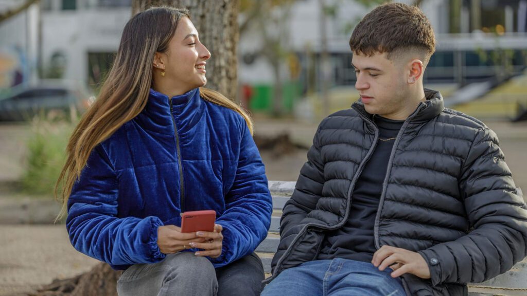 A boy talking to his girlfriend about her life.